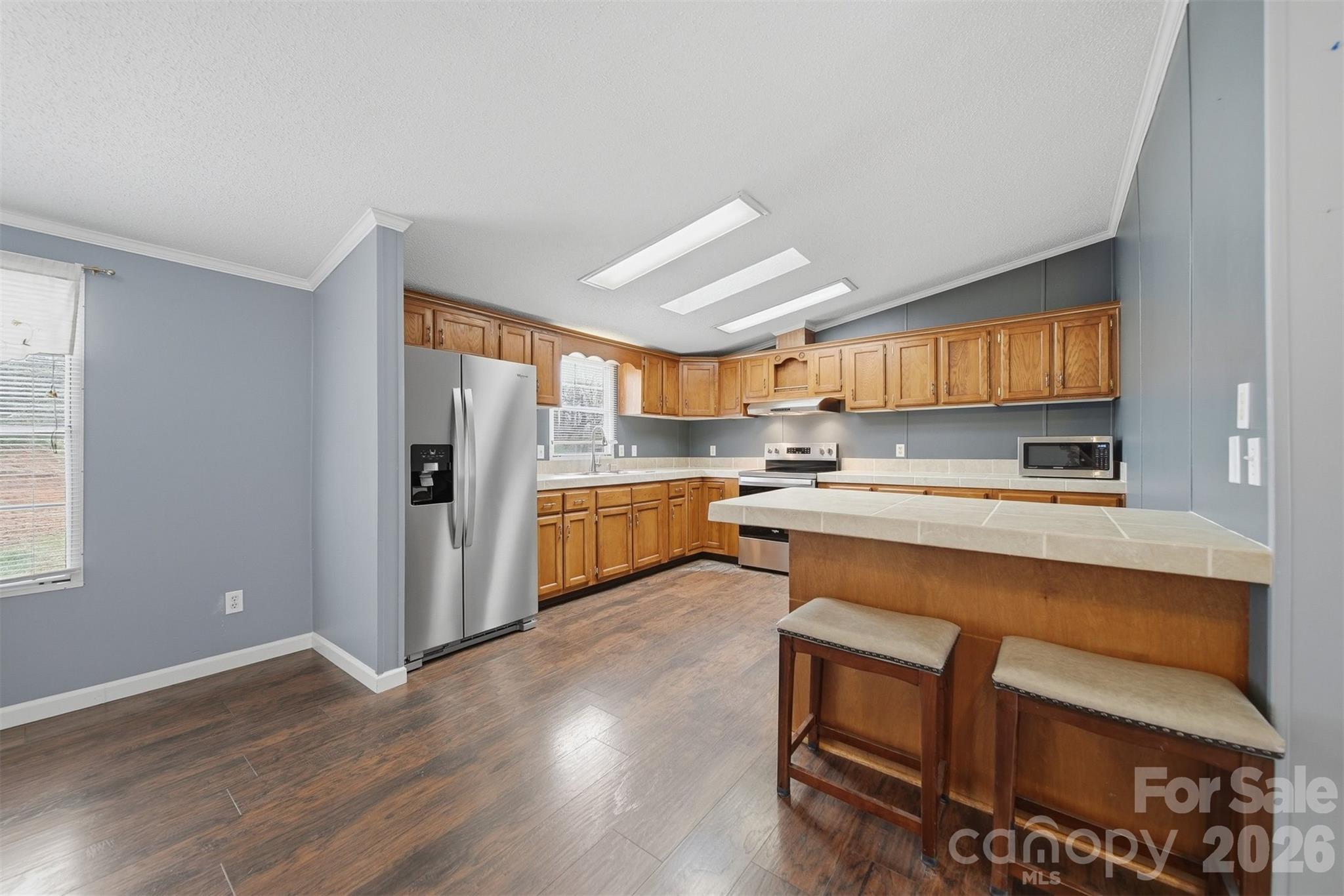 315 West McDowell Street Morganton, NC 28655 - Photo 10 of 48 a kitchen with stainless steel appliances granite countertop a refrigerator and a stove top oven