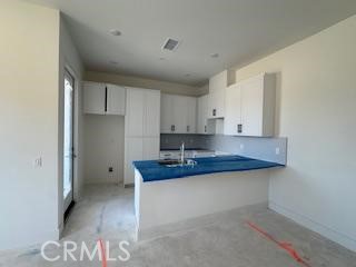 7231 Alchemy Circle Huntington Beach, CA 92647 - Photo 3 of 3 a kitchen with a sink and cabinets