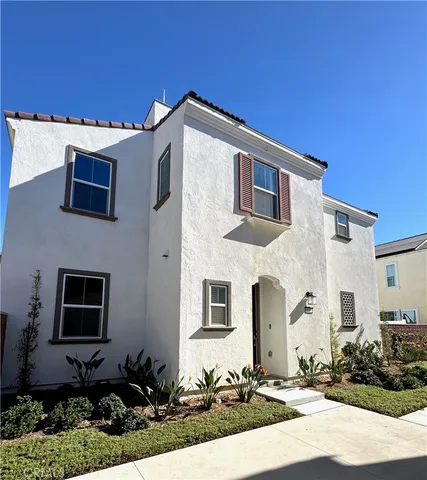 a front view of a house with plants