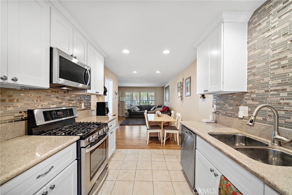 2404 Niagara Way Costa Mesa, CA 92626 - Photo 1 of 19 a kitchen with stainless steel appliances a stove sink microwave and cabinets