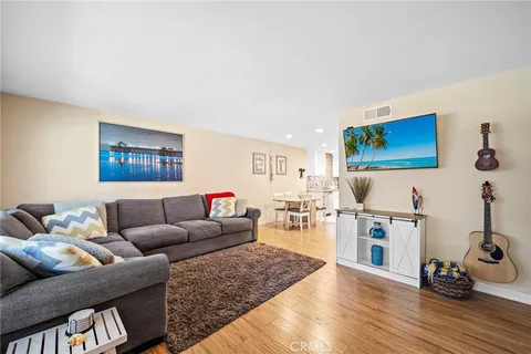 a living room with furniture a rug and white walls