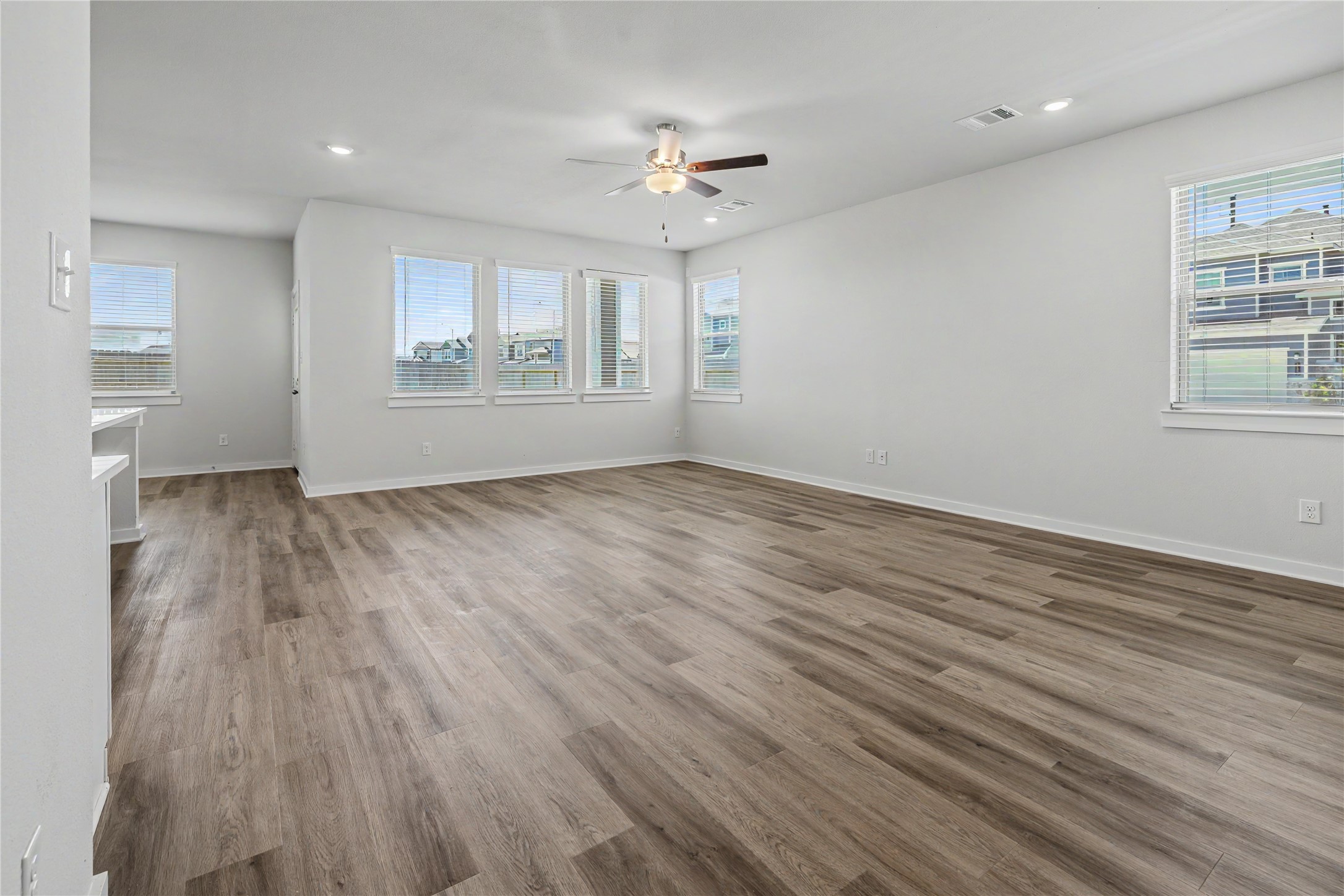 6427 Bolinas Court Rosharon, TX 77583 - Photo 11 of 49 wooden floor in an empty room with a window