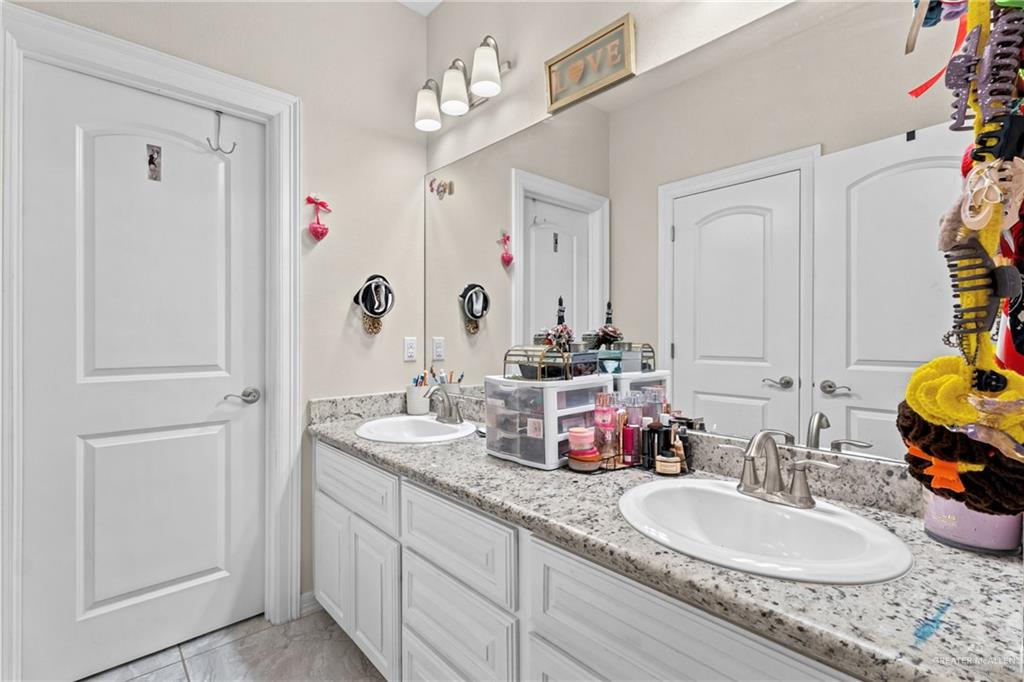 1904 Ridgeway Circle Edinburg, TX 78542 - Photo 20 of 32 Double vanity featuring granite-look countertops and white cabinetry