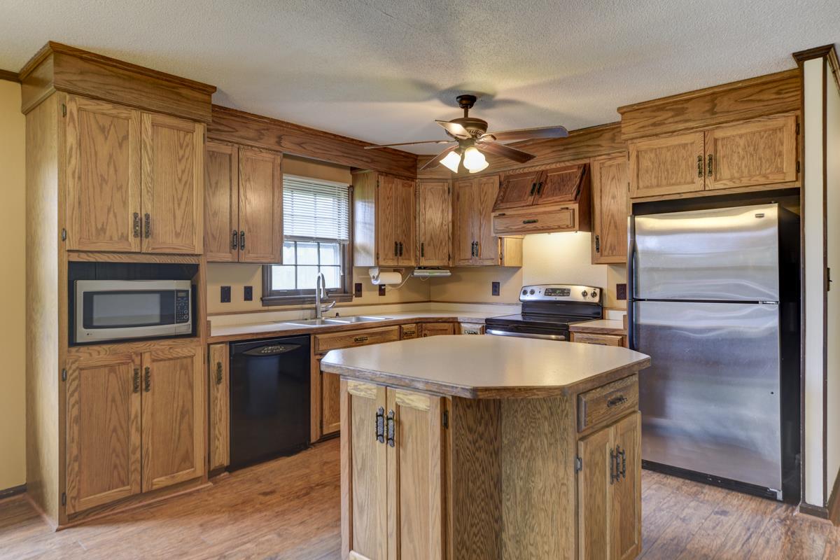 6246 Arno Road Franklin, TN 37064 - Photo 9 of 29 a kitchen with granite countertop a refrigerator a sink a stove and cabinets