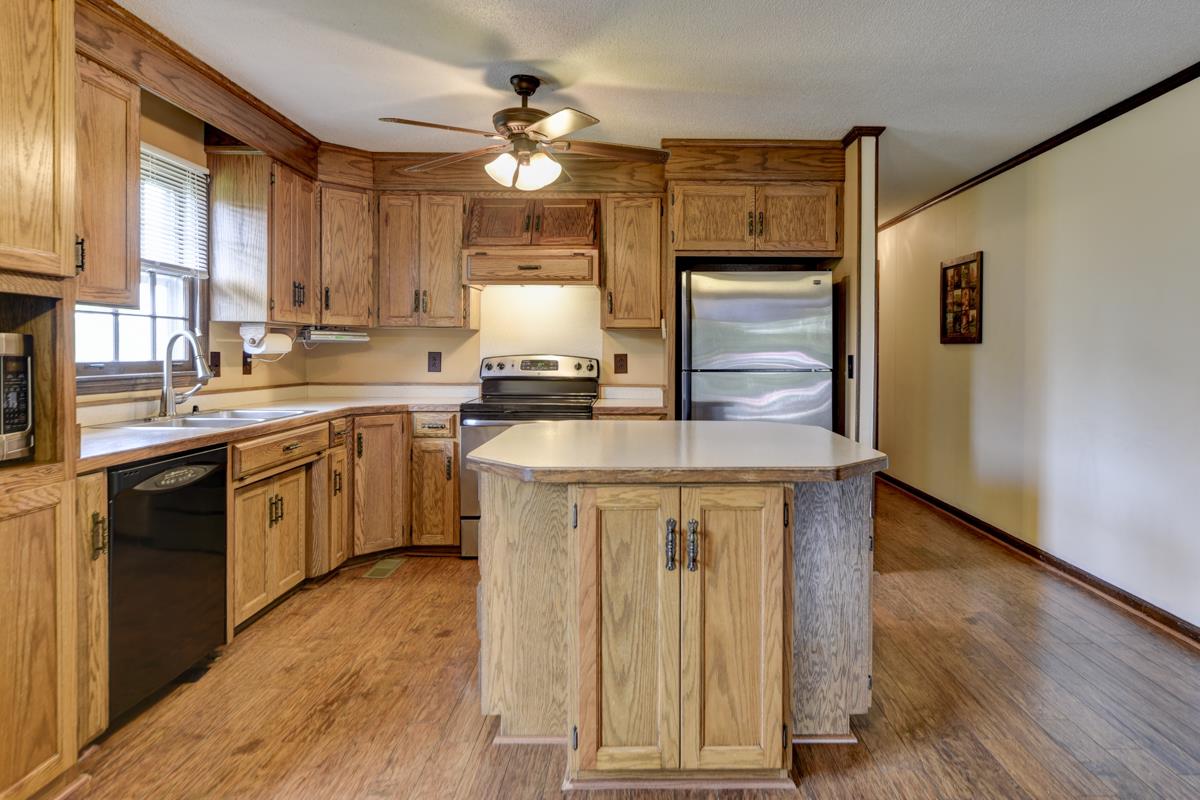 6246 Arno Road Franklin, TN 37064 - Photo 10 of 29 a kitchen with a sink a stove cabinets and wooden floor