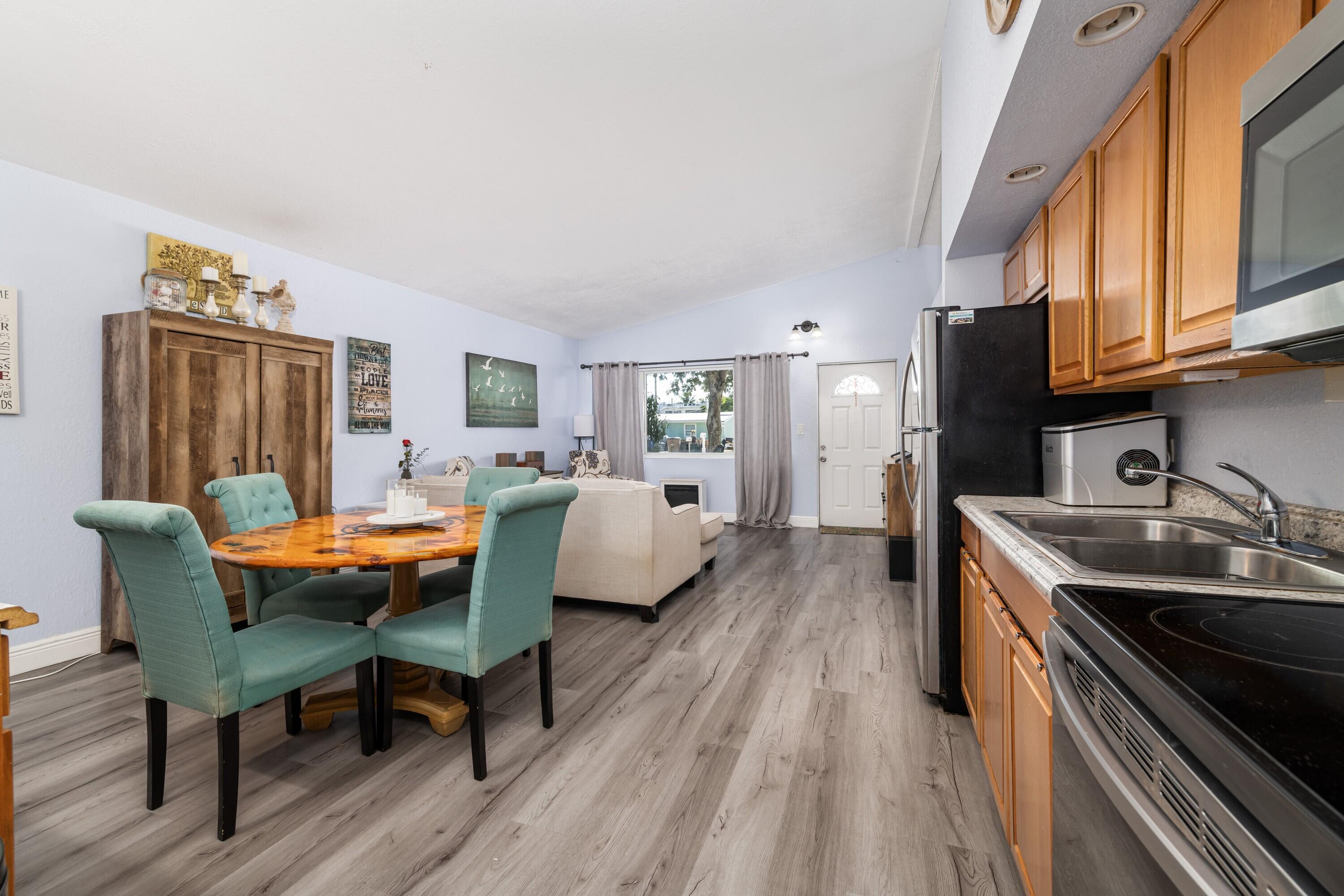 423 80th Street Marathon, FL 33050 - Photo 16 of 39 a living room with stainless steel appliances granite countertop a couch a table and chairs