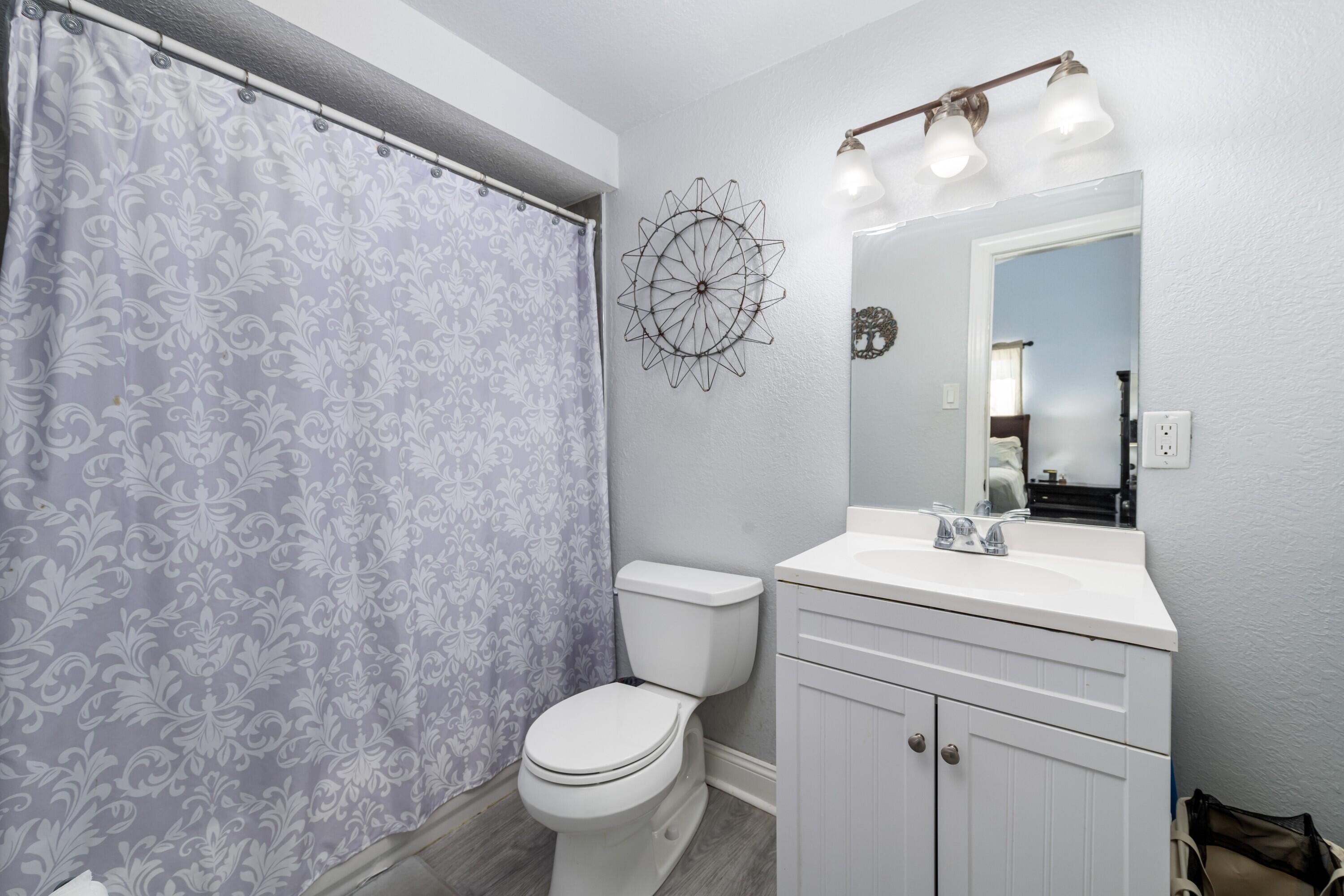 423 80th Street Marathon, FL 33050 - Photo 19 of 39 a bathroom with a toilet a sink and a mirror