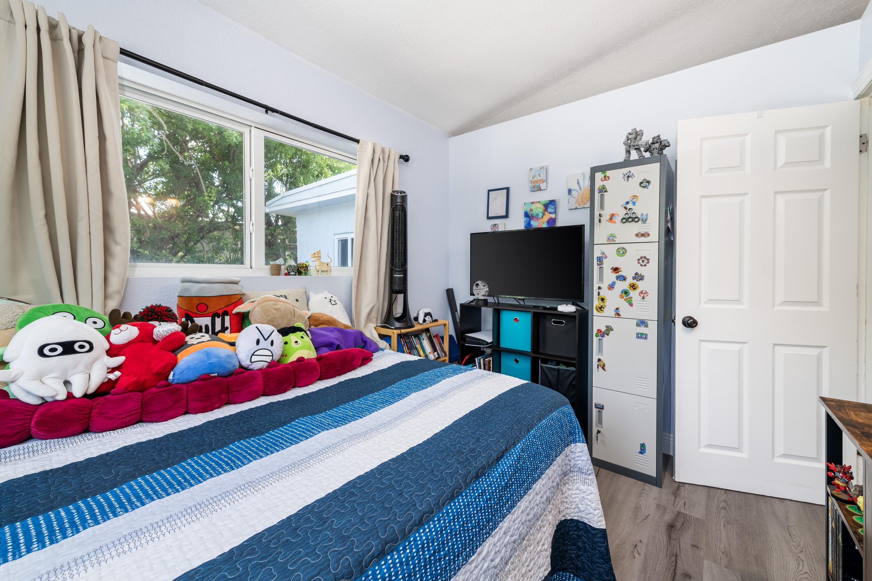 423 80th Street Marathon, FL 33050 - Photo 21 of 39 a bedroom with a bed and flat tv screen on the dresser