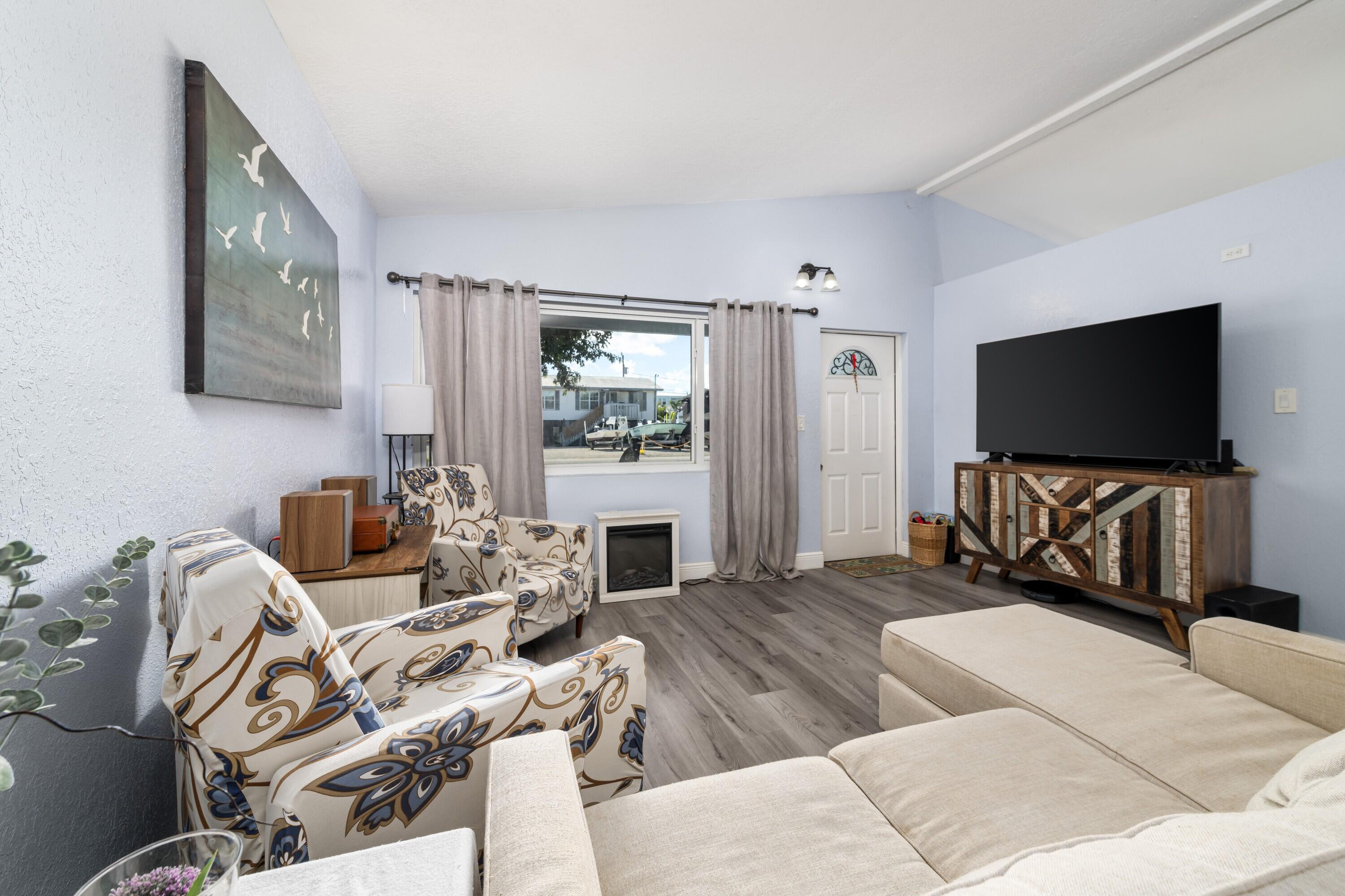 423 80th Street Marathon, FL 33050 - Photo 3 of 39 a living room with furniture and a flat screen tv