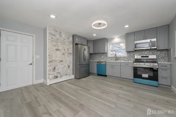 a kitchen with stainless steel appliances a refrigerator sink and cabinets