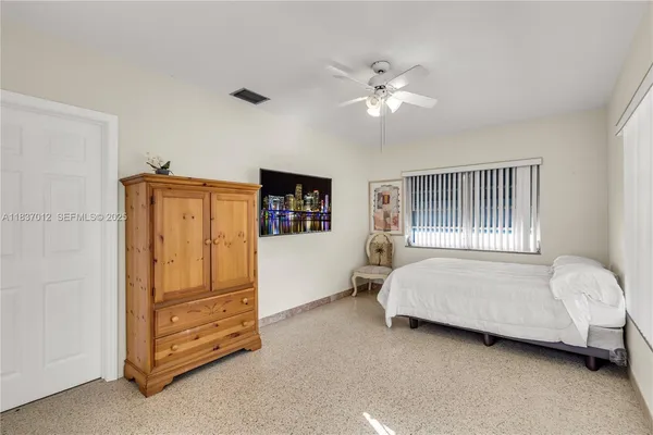 a spacious bedroom with a bed and a chandelier