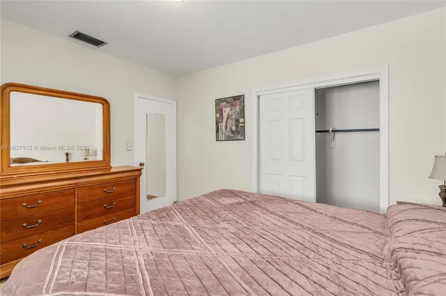 a bedroom with a bed and a dresser