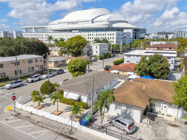 an aerial view of a house with garden space and street view