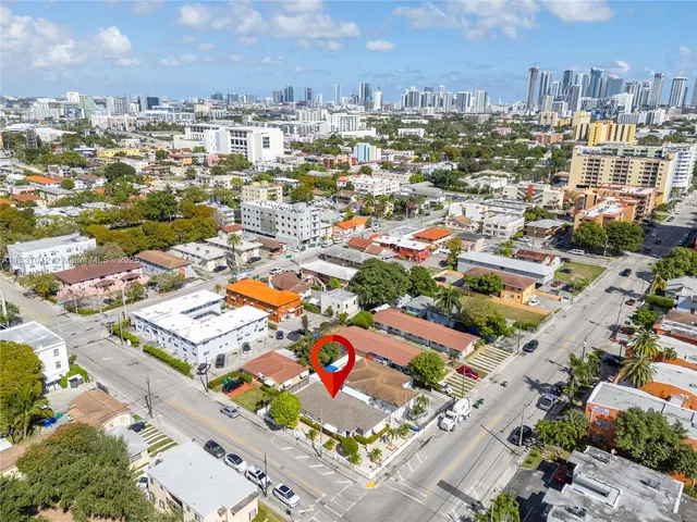 an aerial view of residential houses with city view
