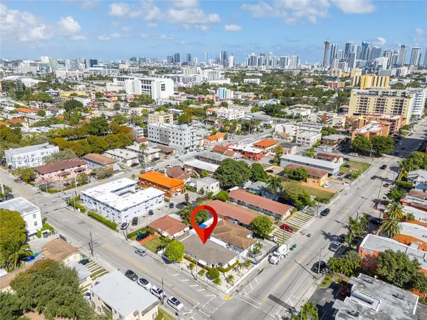 an aerial view of residential houses with city view
