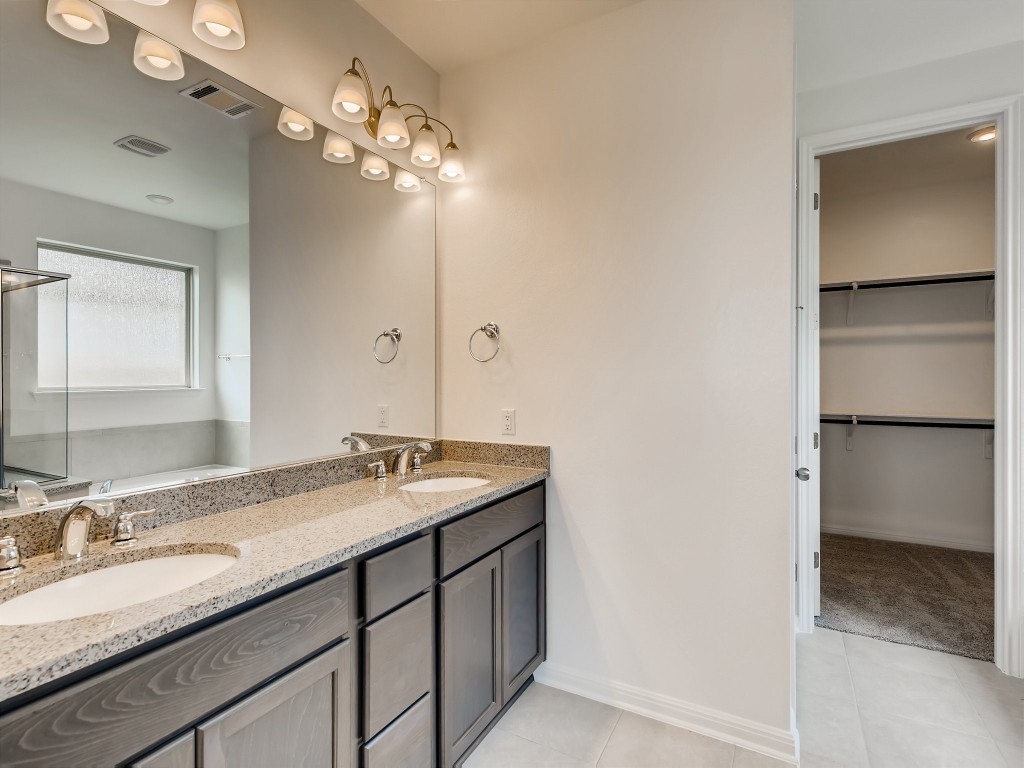 334 Pecos River Crossing Dripping Springs, TX 78620 - Photo 15 of 28 a bathroom with a granite countertop sink and a mirror