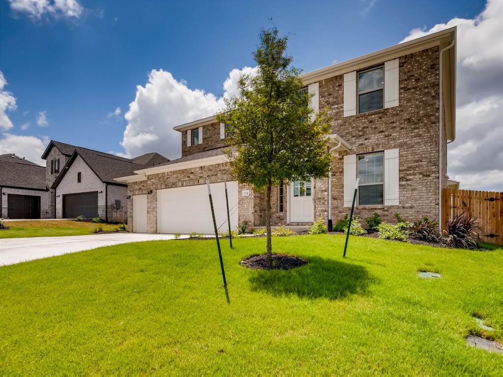 334 Pecos River Crossing Dripping Springs, TX 78620 - Photo 2 of 28 a house view with a play ground in front of it