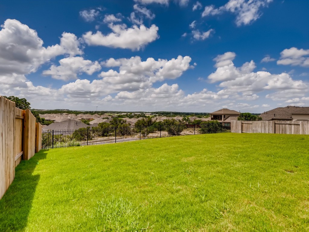 334 Pecos River Crossing Dripping Springs, TX 78620 - Photo 26 of 28 a view of a houses with yard and lake view