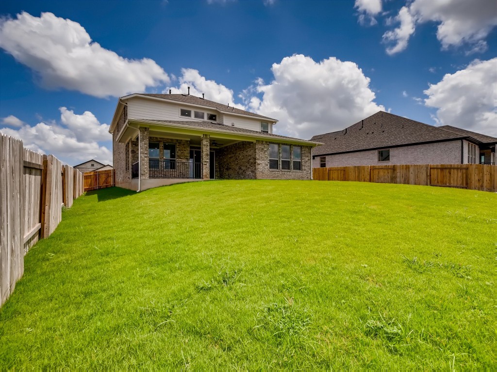 334 Pecos River Crossing Dripping Springs, TX 78620 - Photo 28 of 28 a view of a big house with a big yard and large trees