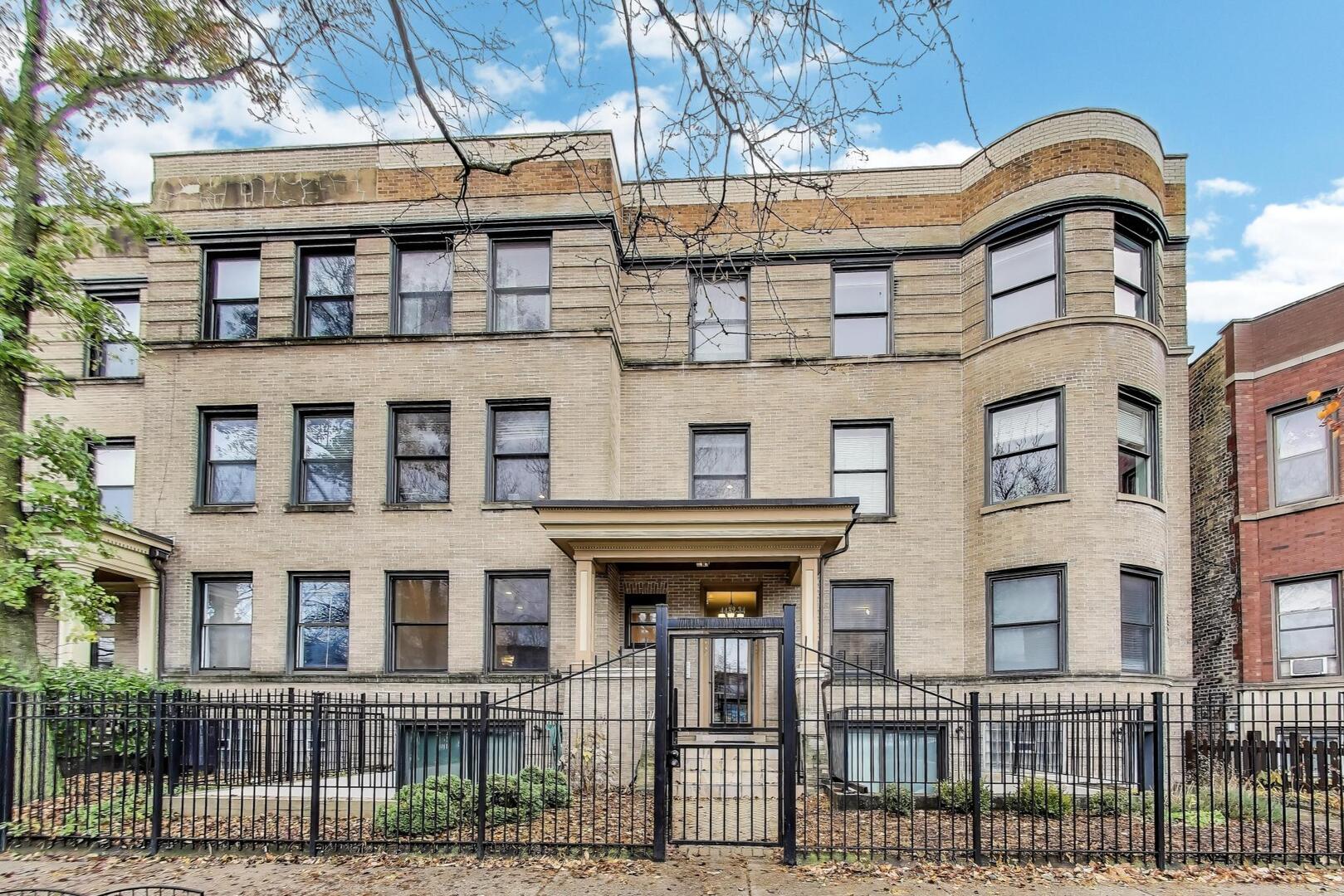 a front view of a residential apartment building with a yard