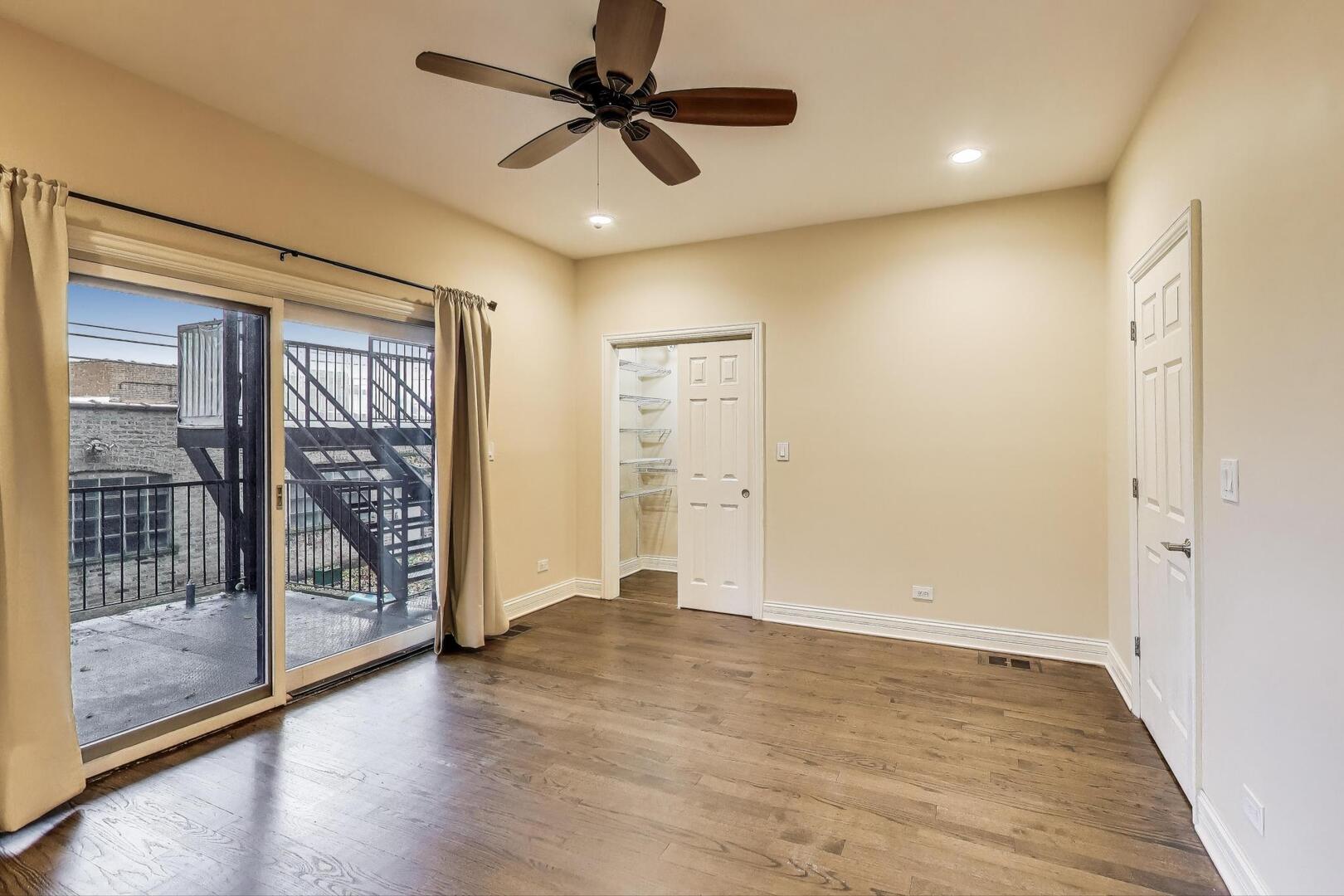 4432 North Dover Street, Unit 1S Chicago, IL 60640 - Photo 12 of 30 wooden floor in an empty room with a window