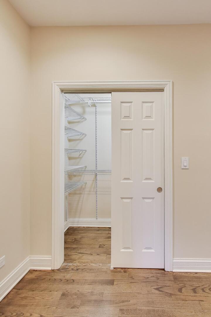 4432 North Dover Street, Unit 1S Chicago, IL 60640 - Photo 16 of 30 an empty room with wooden floor closet and windows