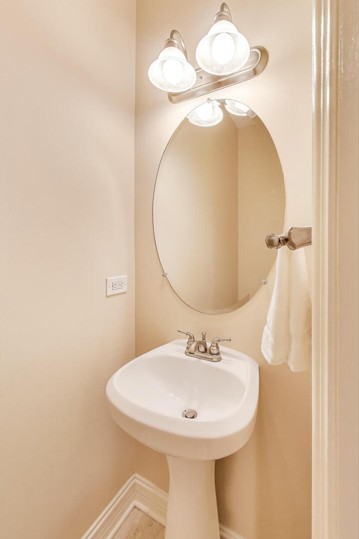 4432 North Dover Street, Unit 1S Chicago, IL 60640 - Photo 18 of 30 a bathroom with a sink and mirror