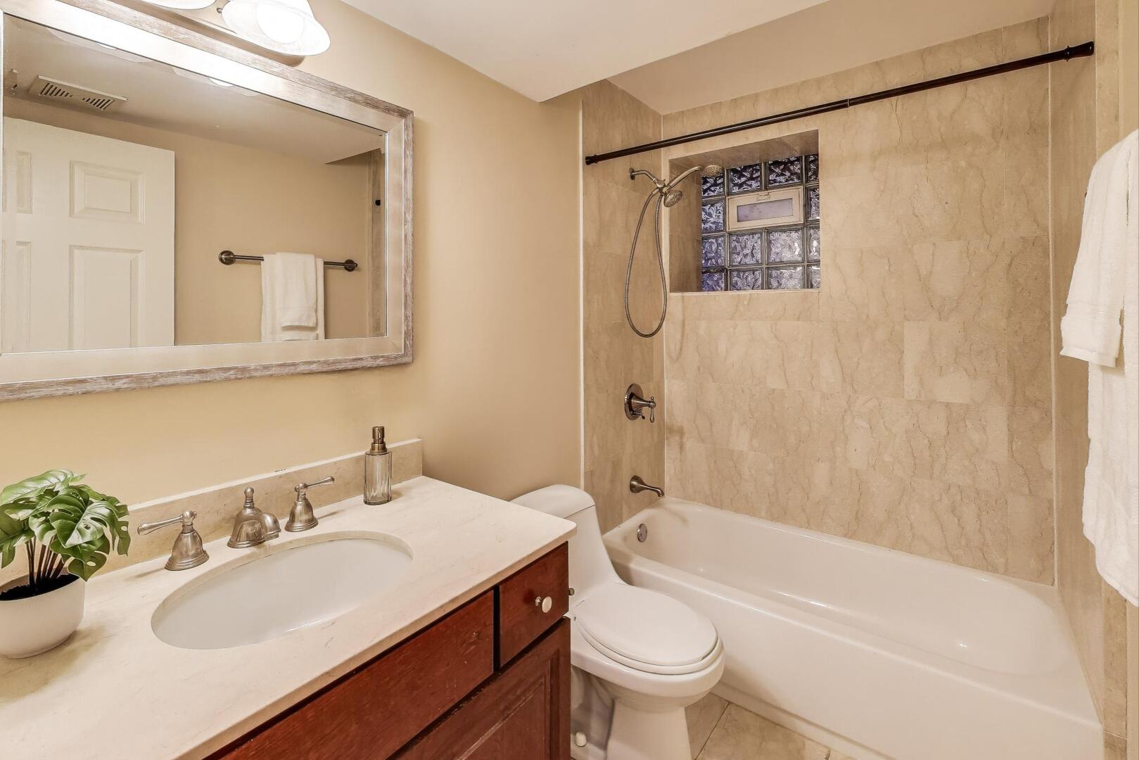 4432 North Dover Street, Unit 1S Chicago, IL 60640 - Photo 28 of 30 a bathroom with a sink toilet tub and shower