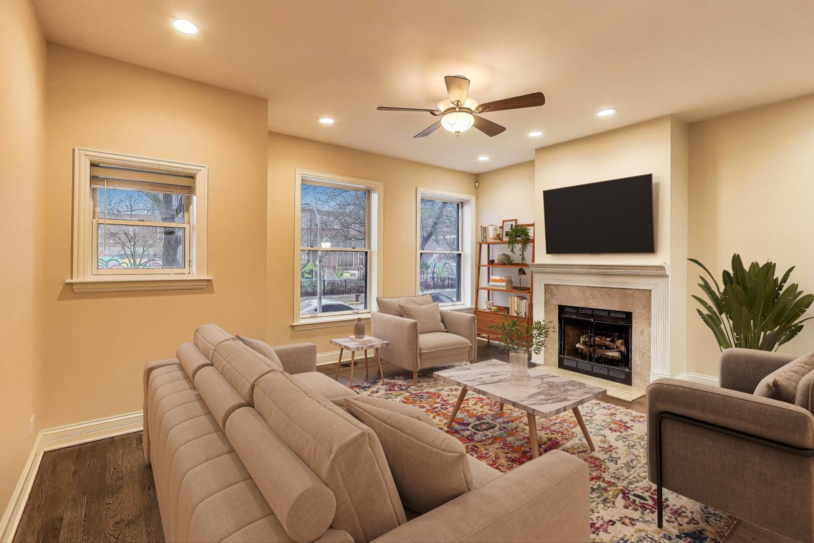 4432 North Dover Street, Unit 1S Chicago, IL 60640 - Photo 4 of 30 a living room with furniture a fireplace and a flat screen tv