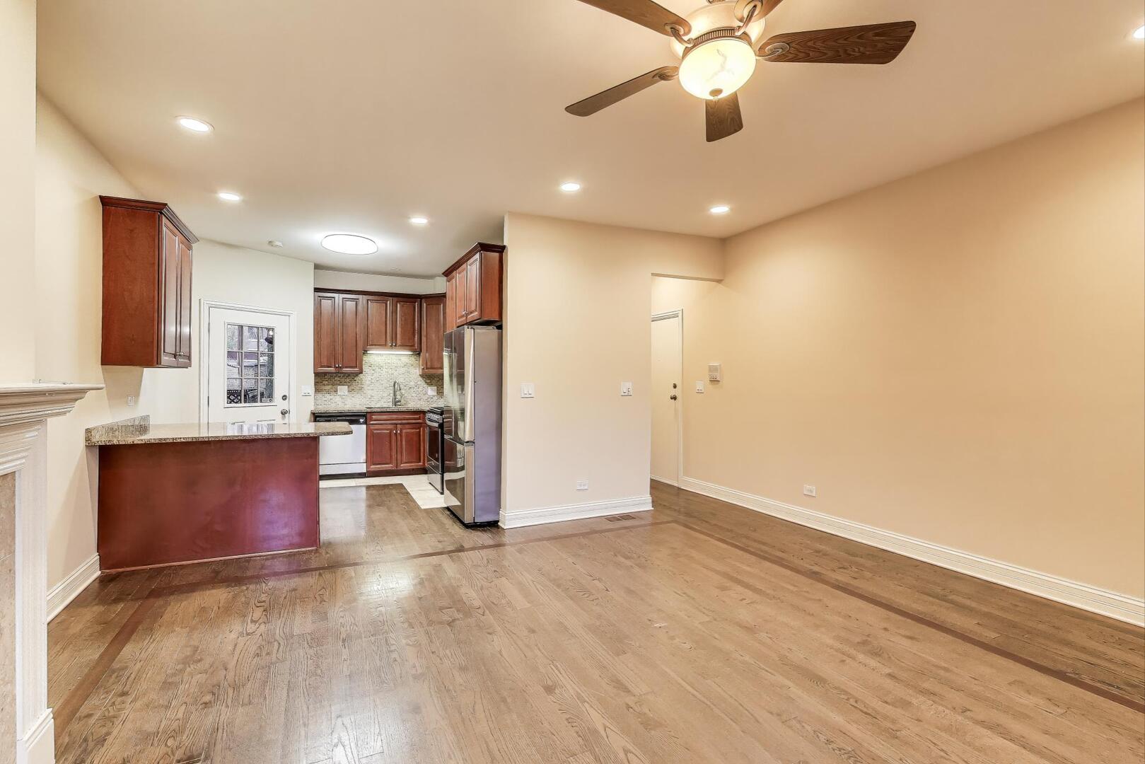 4432 North Dover Street, Unit 1S Chicago, IL 60640 - Photo 6 of 30 a view of kitchen with refrigerator microwave and stove