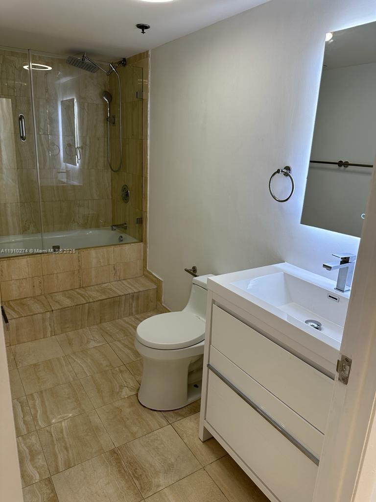 251 Crandon Boulevard, Unit 430 Key Biscayne, FL 33149 - Photo 15 of 19 a bathroom with a toilet sink and a shower