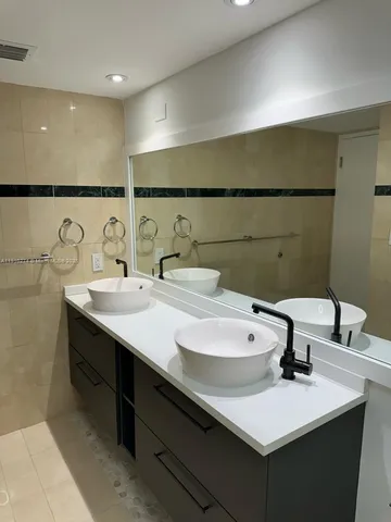 a bathroom with a shower a toilet and a shower