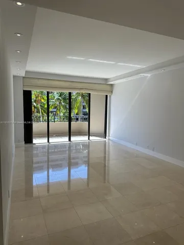 a view of an empty room with glass door