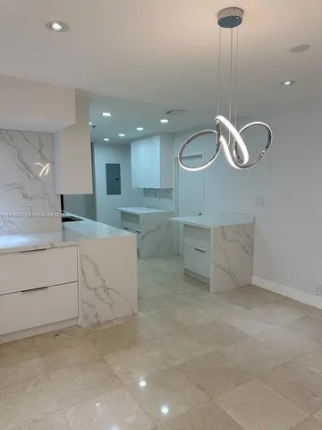 a view of cabinets and chandelier