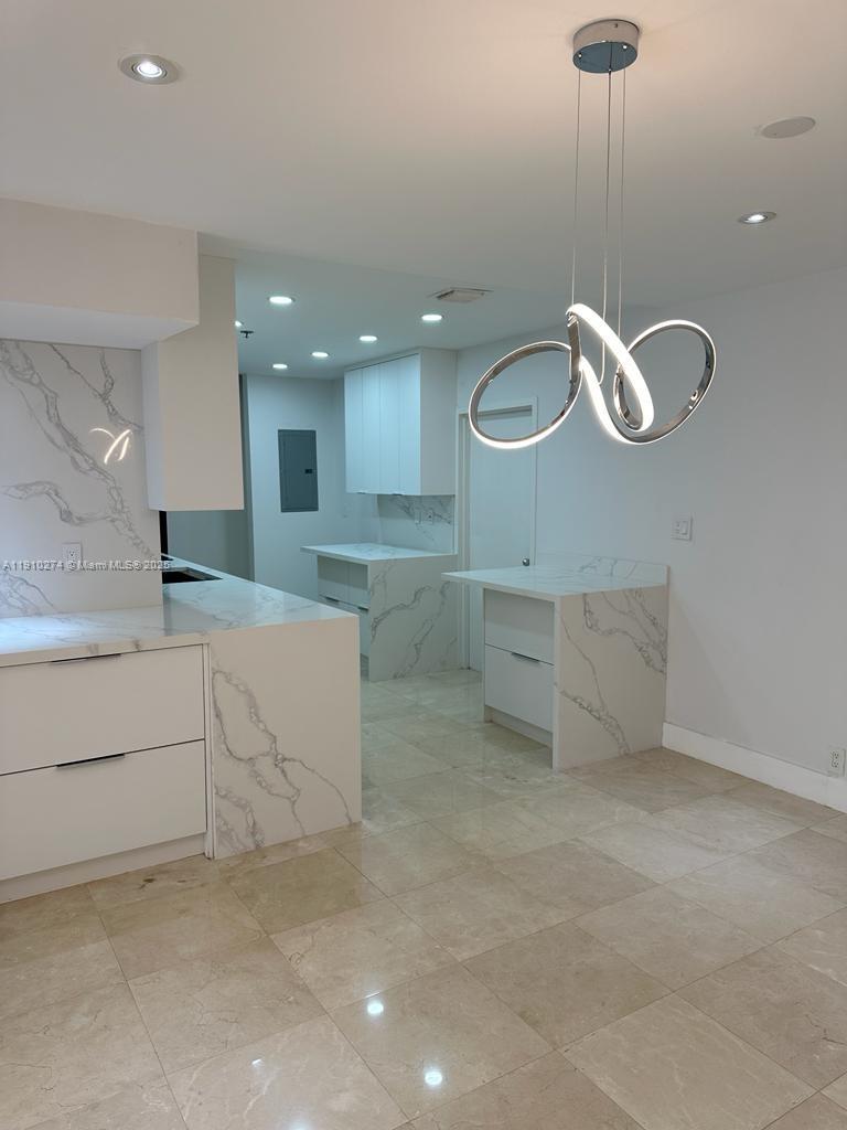 251 Crandon Boulevard, Unit 430 Key Biscayne, FL 33149 - Photo 8 of 19 a view of cabinets and chandelier