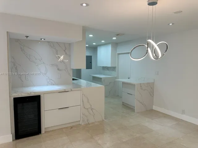 a kitchen with cabinets and window