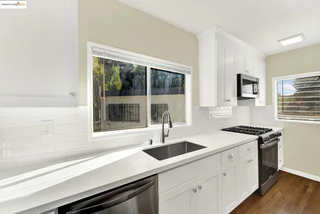 a kitchen with a sink stove and cabinets