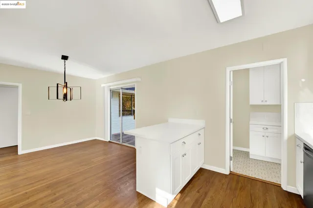 a bedroom with a bed table and a window