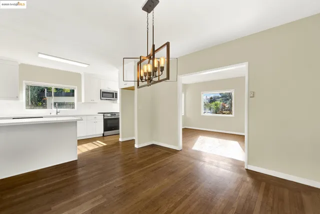 a view of a room with wooden floor and window