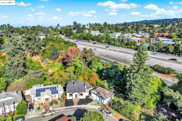 an aerial view of residential houses with outdoor space and street view