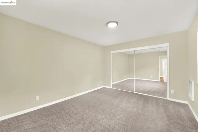 a view of a balcony with two chairs and a table