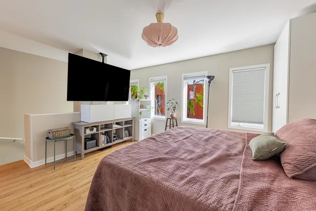 a bedroom with a bed and a flat screen tv