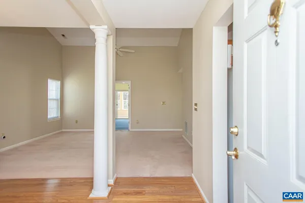 a living room with furniture a table and a chandelier