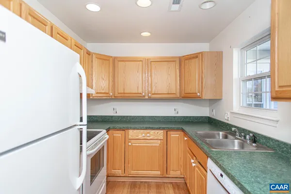 a kitchen with stainless steel appliances granite countertop a sink stove and cabinets