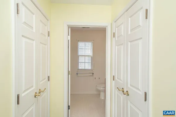 a bathroom with a sink vanity granite toilet and a mirror
