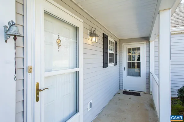 a view of a hallway with wooden floor and closet
