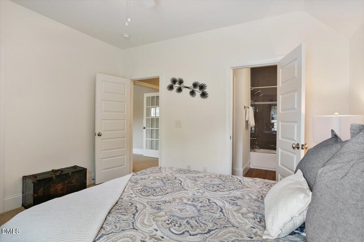 1404 Ivy Lane Raleigh, NC 27609 - Photo 27 of 37 White paneled interior doors, light-colored walls, and wood-finish flooring