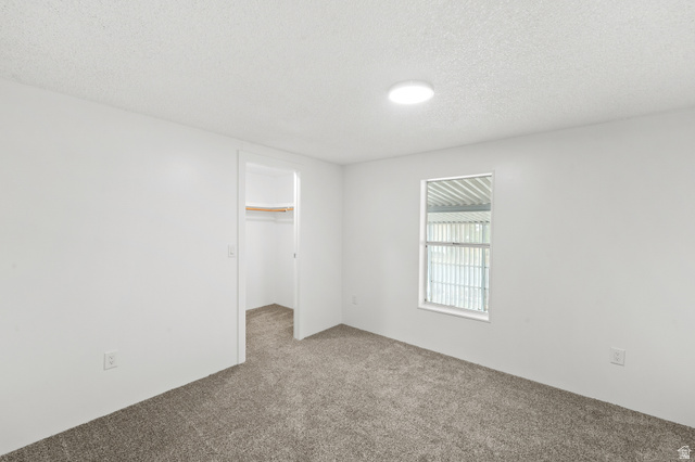 2875 North 400 West, Unit 7 Layton, UT 84041 - Photo 17 of 29 Neutral tone walls with textured ceiling and a single window
