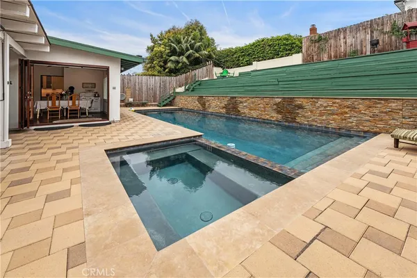 a kitchen with stainless steel appliances refrigerator dining table and chairs
