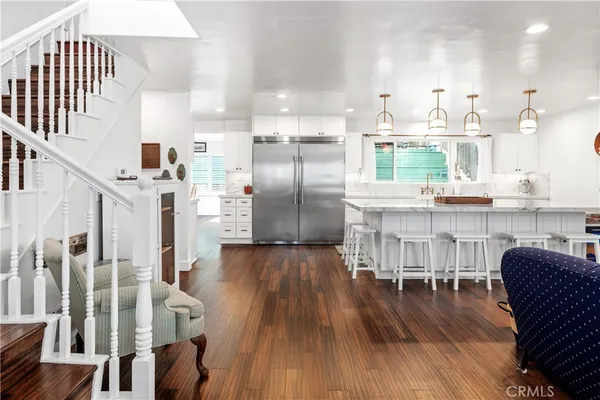 a spacious bathroom with a granite countertop double vanity sink and a large mirror